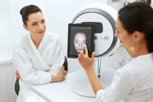 Cosmetologist Analyzing Woman Facial Skin