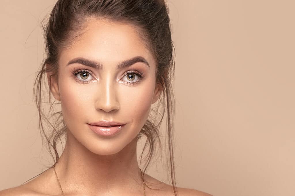 Woman has attractive nose shape after cosmetic and functional rhinoplasty.